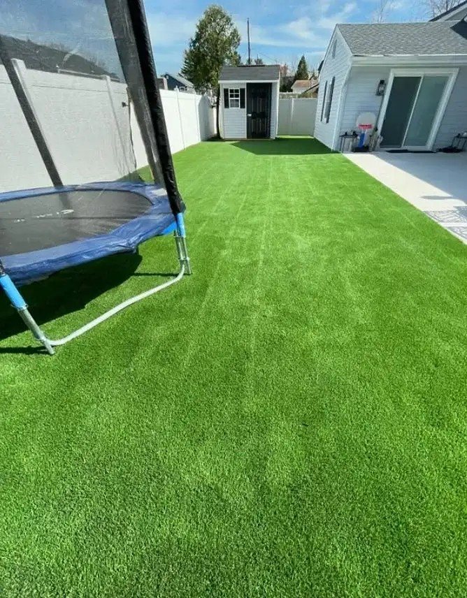 Freshly installed synthetic turf lawn by Turf Boss Construction