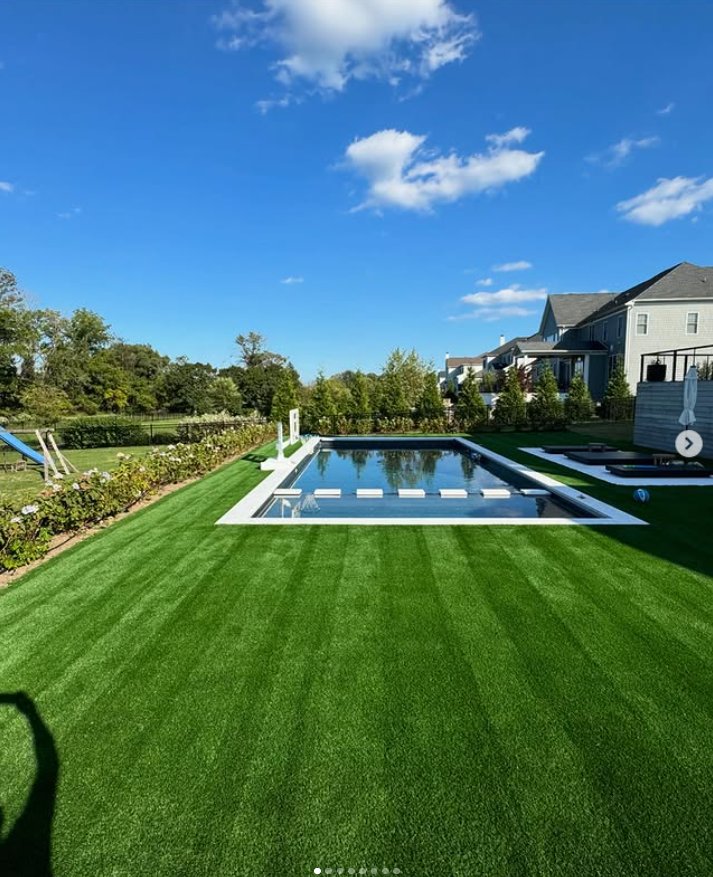 Luxury poolside turf installation with blue sky