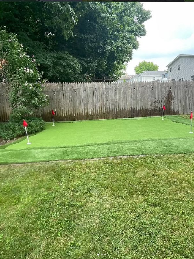 Backyard putting green with red flags