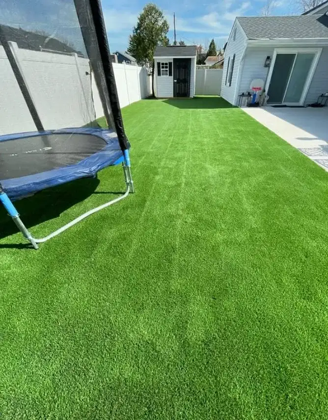 Lush artificial grass backyard installation by Turf Boss Construction NJ
